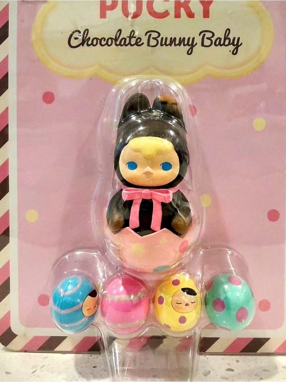 Pucky Chocolate Bunny Baby Figure with Pink & Black Outfit and Colorful Eggs